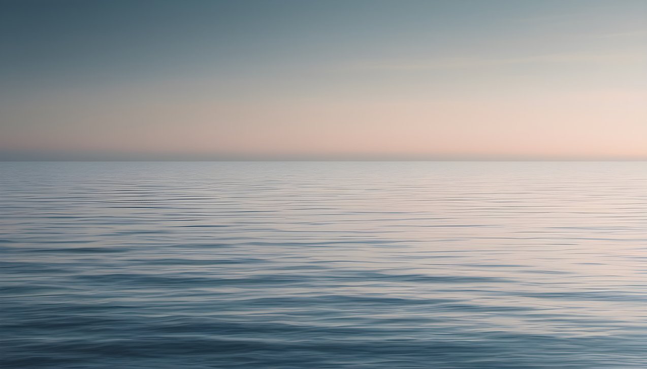A thin horizon line over a gradient sea with vast negative space
