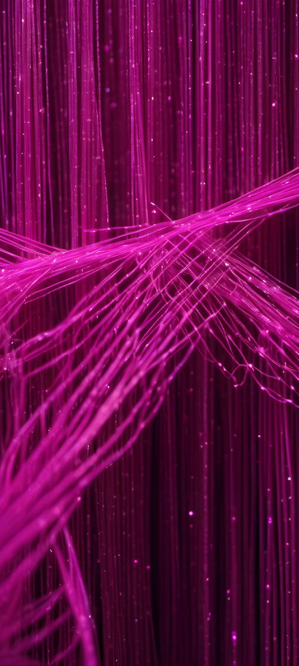 Fiber optic strands glowing magenta on black in a dark studio