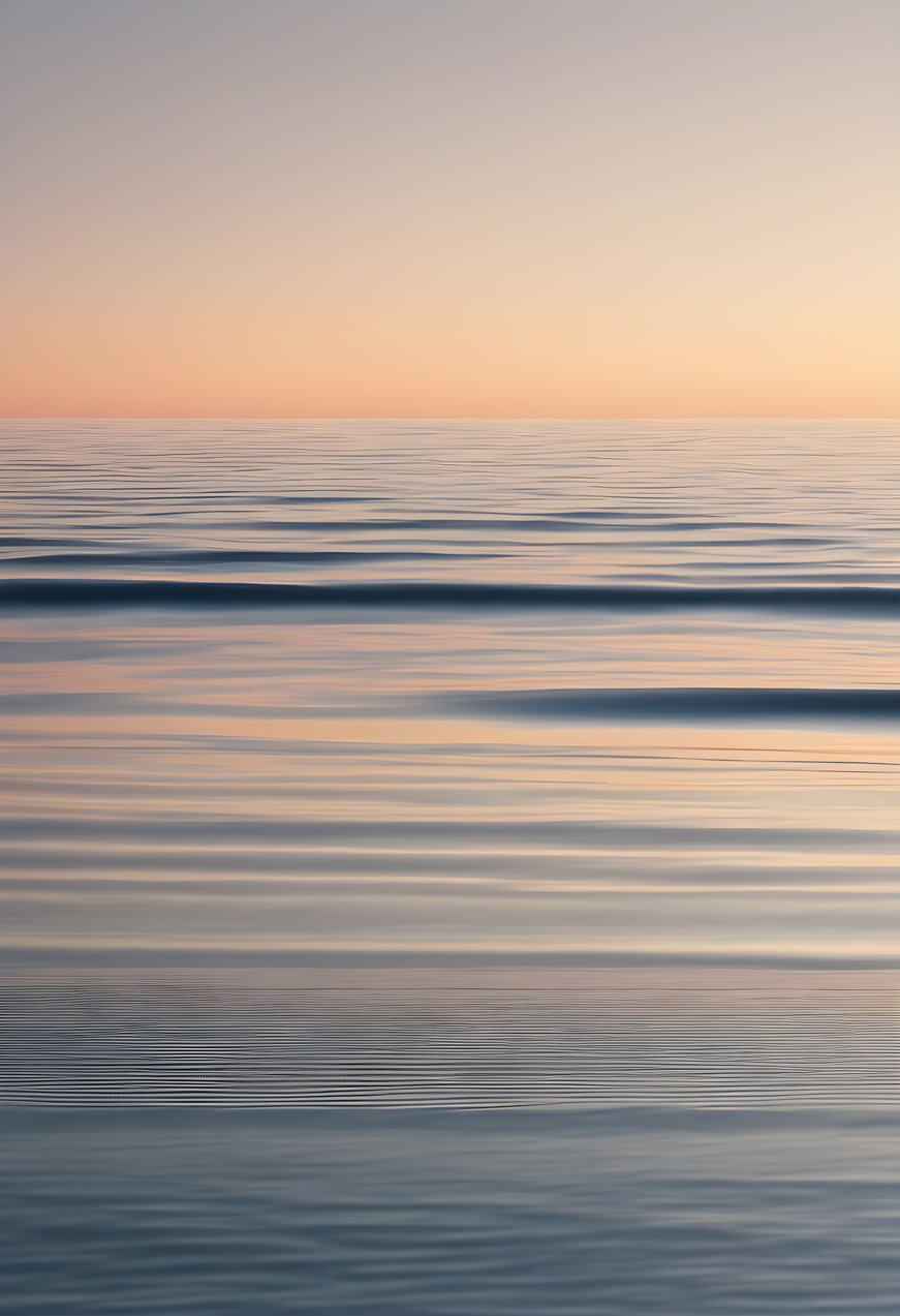 A thin horizon line over a gradient sea in soft morning light