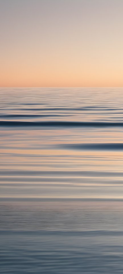 A thin horizon line over a gradient sea in soft morning light