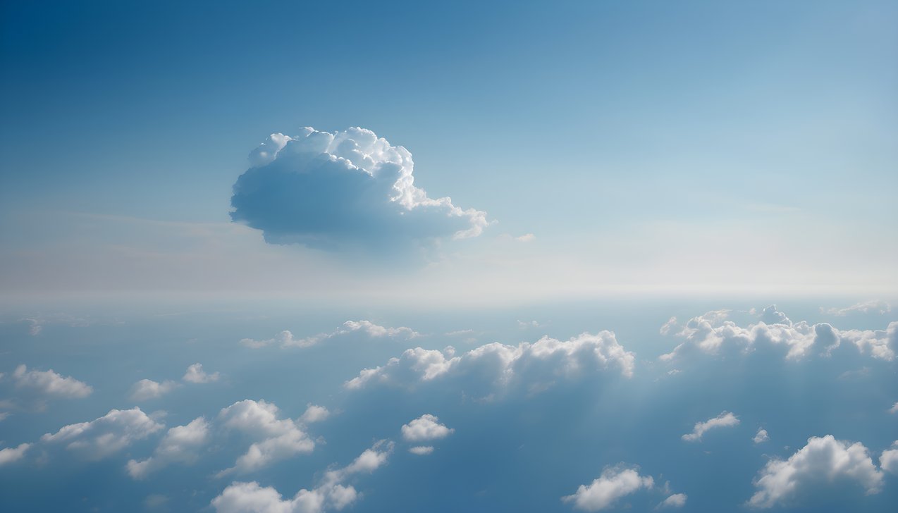 One small cloud drifting in a vast blue sky in soft morning light